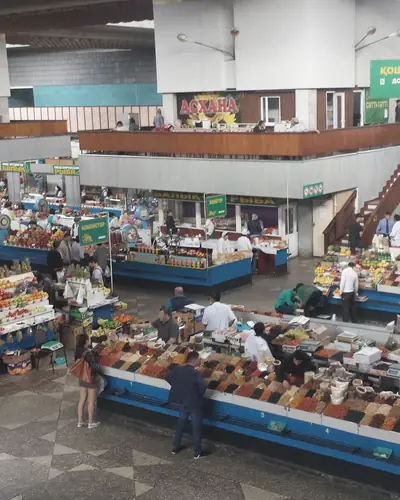 Indoor market hall with long counters of dried fruit, nuts and spices